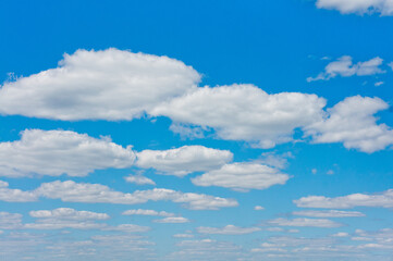 Bright blue sky with white clouds. Photographed on a sunny summer day.