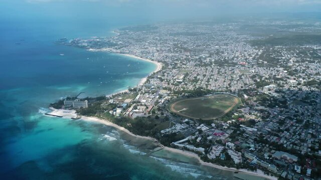 Aerial view to the island, horse riding track, sea, yacht, ships in Bridgetown, Barbados