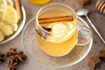 hot herbal tea with lemon, ginger and honey in glass mugs