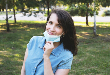 Portrait of happy young woman wearing medical protective mask. Coronavirus lifestyle concept, new normal