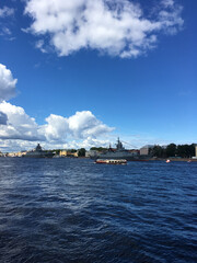 Fototapeta premium Warships in the water area of ​​the Neva, arrived to participate in the naval parade in St. Petersburg, near pleasure boats with tourists.