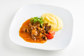 meat with mashed potato on the white plate