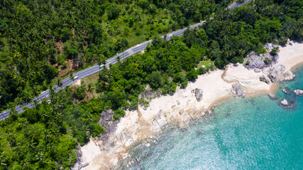Aerial view of ocean road, road on sea coastal, Car drive on the empty asphalt road running along the shoreline, Tourist car cruises down the scenic coastal road.