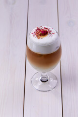 latte with rose on the wooden background