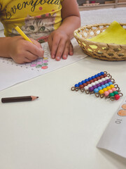 the child learns mathematics and drawing with the help of a stairs made of colored beads