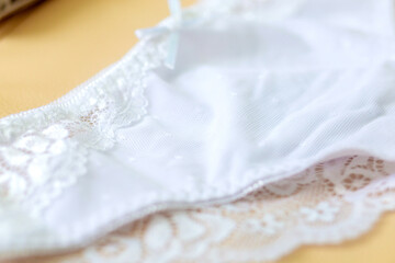 Decoration of women's underwear. White ribbon bow on delicate panties for women