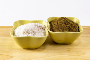 spices salt crushed cumin flavor gives on a wooden table a white background
