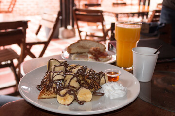 waffles with banana and chocolate syrup breakfast 