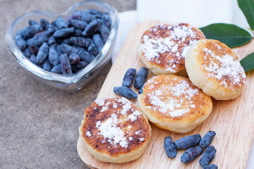 honeysuckle berries on a concrete background.