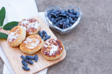 honeysuckle berries on a concrete background.