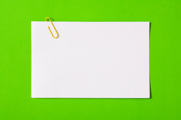 white sheet of paper for notes and paper clip
