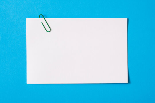 white sheet of paper for notes and paper clip

