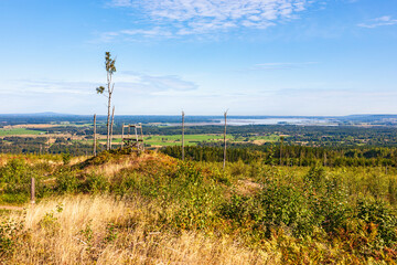 Fototapeta premium Hunting tower on a hill at a clearcut area an a landscape view