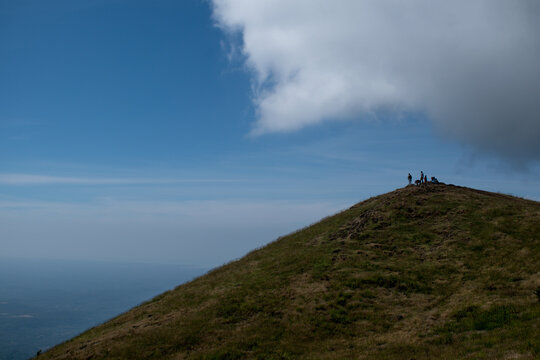 Clouds over the mountains. The tourist enjoying the beauty from the top. 