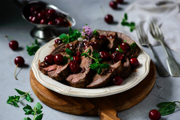 Roast beef with cherry sauce.style rustic.