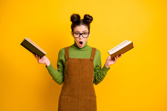 Portrait of her she nice attractive wondered astonished amazed knowledgeable girl nerd reading book history science isolated bright vivid shine vibrant yellow color background