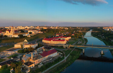 Fototapeta na wymiar Panoramic view of the city of Grodno, the embankment, the Neman river and the old city. Autumn evening, the city in the sunshine against a background the blue sky.