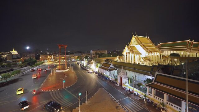 The Giant Swing or Sao Ching Cha monument with Wat Suthat temple at night in old town, Bangkok City, Thailand. Landmark tourist attraction. Thai architecture with travel trip concept.