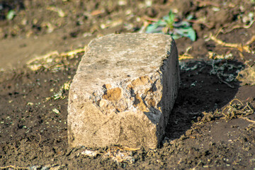 Old white brick lies on the ground, photo for design