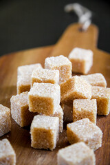 Brown cane sugar cubes on a cutting board