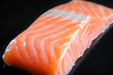 Salmon steak isolated on black background