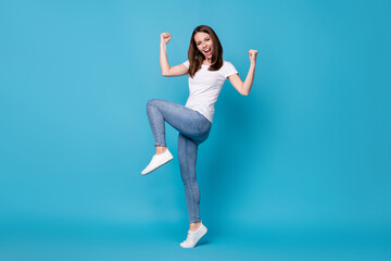 Full length photo of attractive crazy lady good mood raise fists screaming overjoyed football sports fan supporter competitive wear casual white t-shirt isolated blue color background