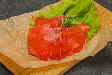 Sliced salmon fillet served rosemary