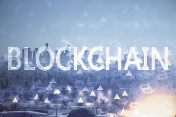 Double exposure of crypto currency theme hologram drawing and city veiw background. Concept of blockchain and bitcoin.