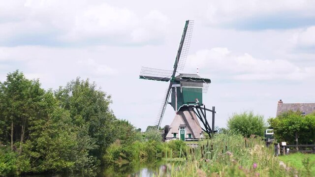 4k Windmill Oukoopse Molen standing in typical Dutch nature near channel-2.