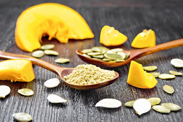Flour and seeds pumpkin in spoons on board