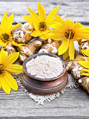 Obraz na płótnie Canvas Flour of Jerusalem artichoke in bowl on napkin