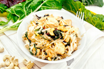Funchoza with chard and cashew in bowl on napkin