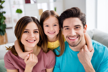 Close up photo of loving tender gentle family mother father and small kid girl cuddle hug embrace...