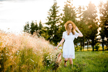 Glow Sun. Selective focus, lifestyle.Beauty Girl Outdoors enjoying nature. Beautiful Model girl in white dress running on the Field, Sun Light. . Free Happy Woman. Toned in warm colors. Autumn.