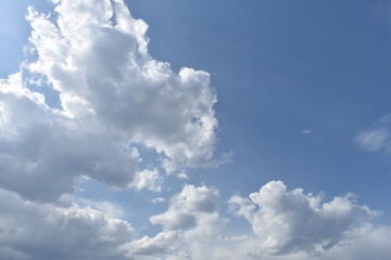 Naklejka na ściany i meble white clouds fly across the blue sky
