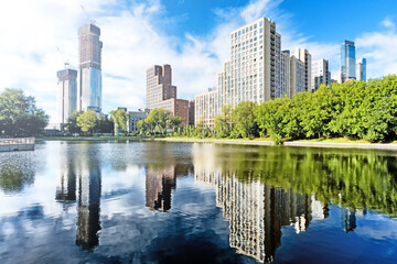 Obraz premium downtown moscow city russia panorama landmark against blue sky background. Modern residential building and park with duck pond urban street landscape view. Summer in city