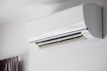 Air conditioner on white wall room interior background