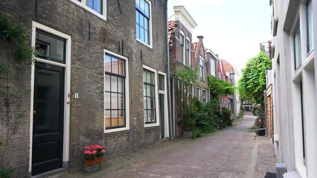 4k-Gouda, Dutch, Old monumental alley Ancient narrow street. Architecture, old houses, streets and neighborhoods. Shot in 4K (ultra-high definition (UHD)