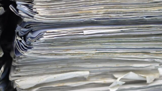 Stack of documents on desktop in office.