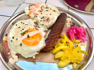American Style Breakfast Croque Madame with Sausage, Pickled Turmeric Onions and Pickle.