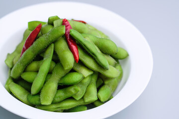 A traditional Chinese delicacy in solid color, boiled soybeans in brine. Chinese traditional food boiled soybean