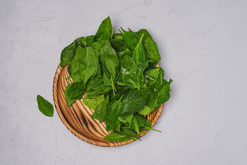 
Healthy food concept. Fresh green spinach on a wooden tray. Top view.