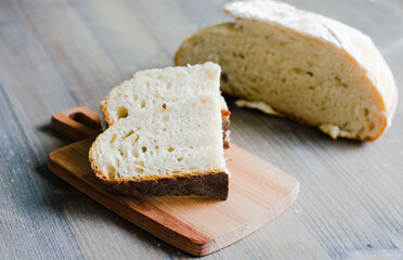 Pieces of homemade bread on the small wooden pan
