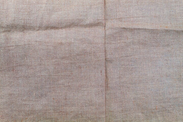 View from above at a brown linen rag with irregularities