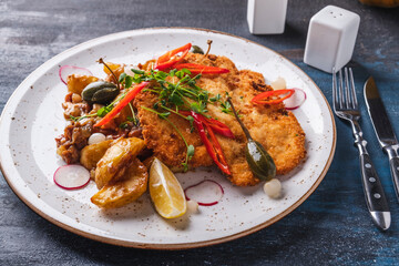 Crispy chicken in breading with potato