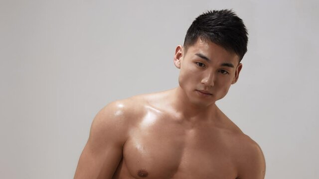 Muscular Asian Man Indoors in th Studio
