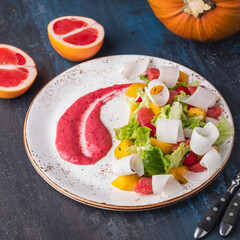 Diet salad with grapefruit and pumpkin, lettuce and red sauce