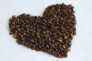 Coffee beans in heart shape on the white background