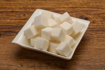 Refined white sugar cubs in the bowl