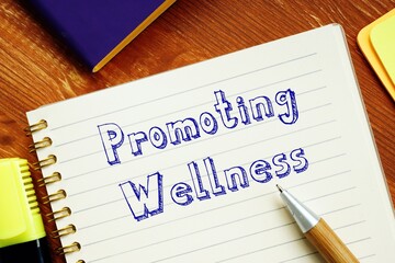 Promoting Wellness sign on the piece of paper.